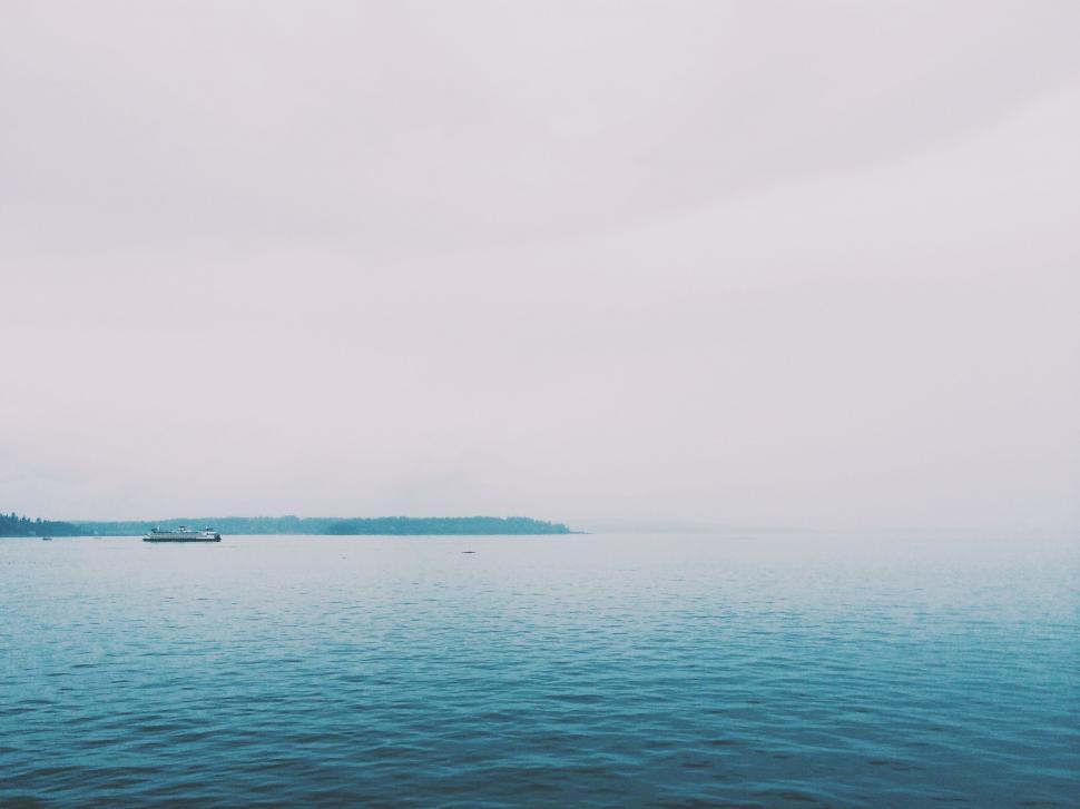 Free Image of Large Body of Water Under Cloudy Sky 