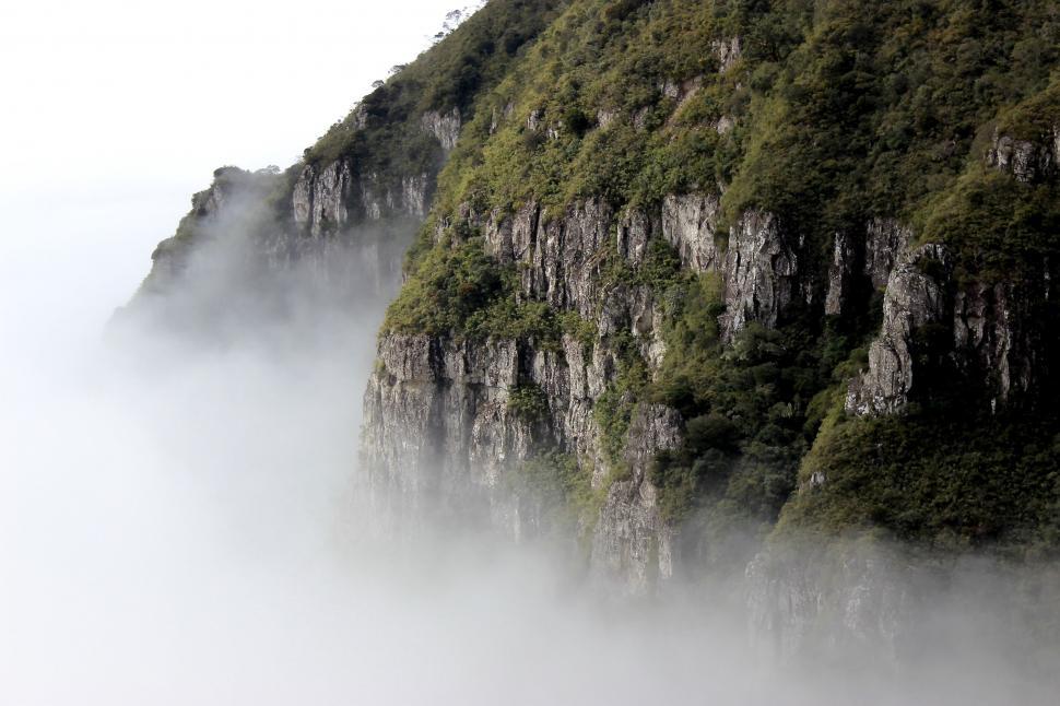 Free Image of Mountain Covered in Fog and Mist on Cloudy Day 