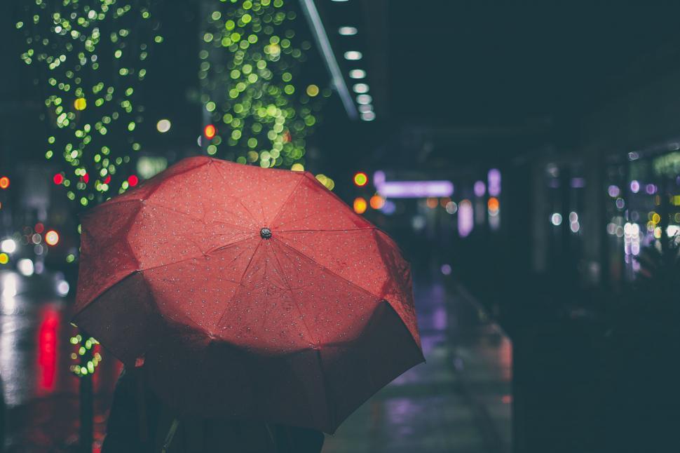 Free Image of Person Holding Red Umbrella on Rainy Night 