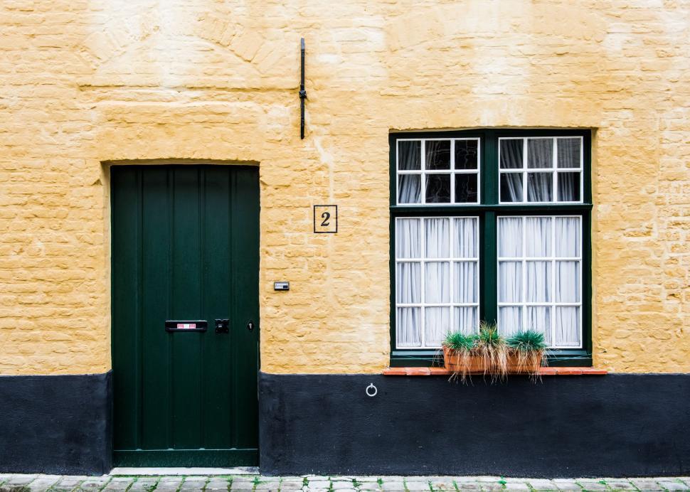 Free Image of Yellow Building With Green Door and Window 