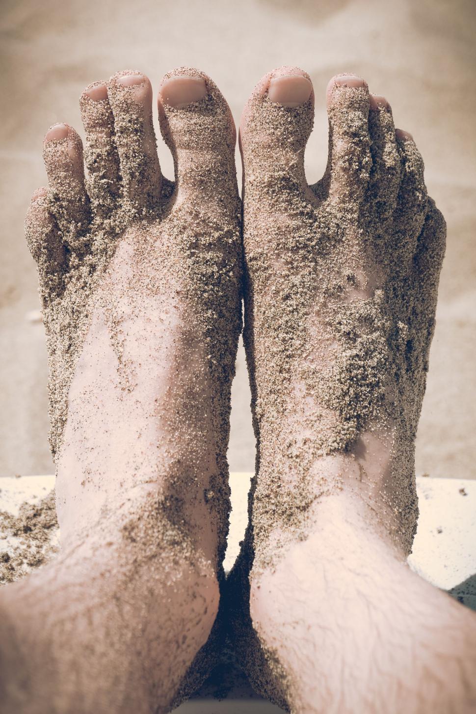 Free Image of Persons Feet Covered in Sand on the Beach 