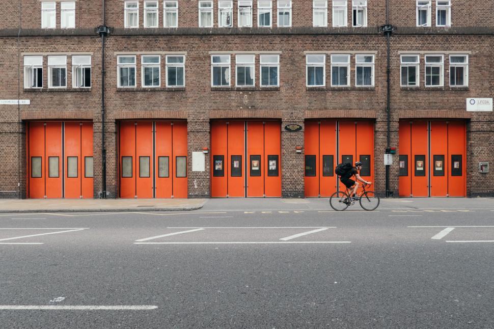 Free Image of Person Riding Bike in Front of Building 