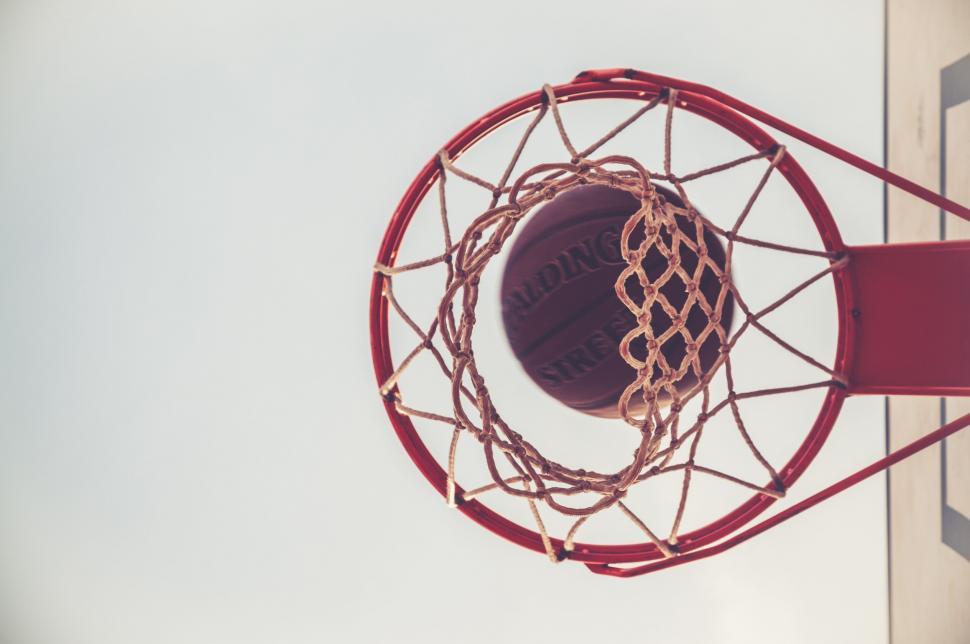 Free Image of Basketball Going Through the Rim of a Basketball Hoop 