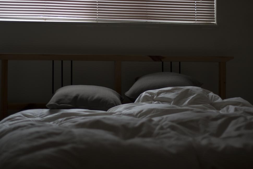 Free Image of Bed in a Dark Room 