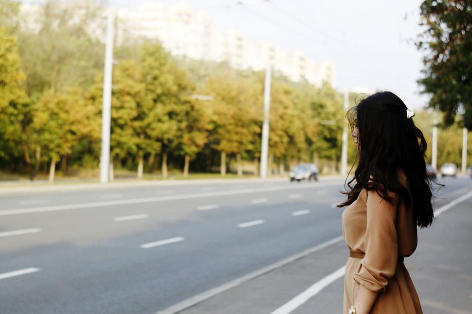 Free Image of Woman Standing on Side of Road 