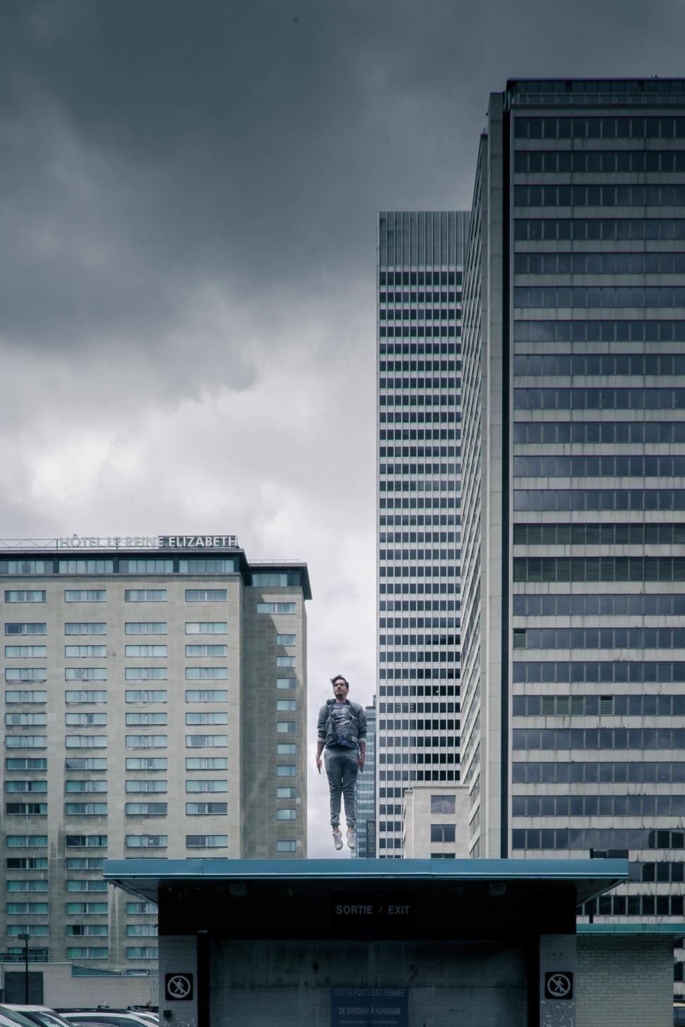 Free Image of Man Standing on Roof in Urban Setting 