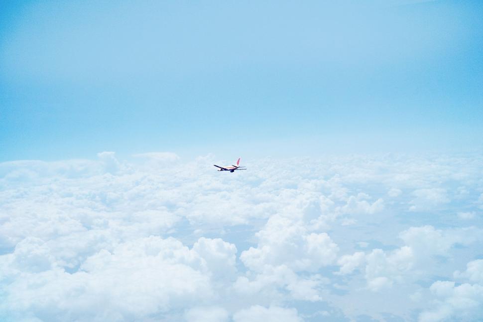 Free Image of Airplane Flying High Above Clouds 