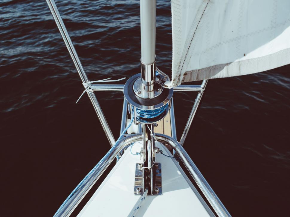 Free Image of Sailboat With White Sail on Body of Water 