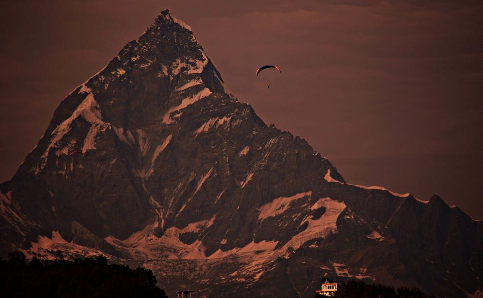 Free Image of Majestic Mountain Peak With Bird Flying Overhead 