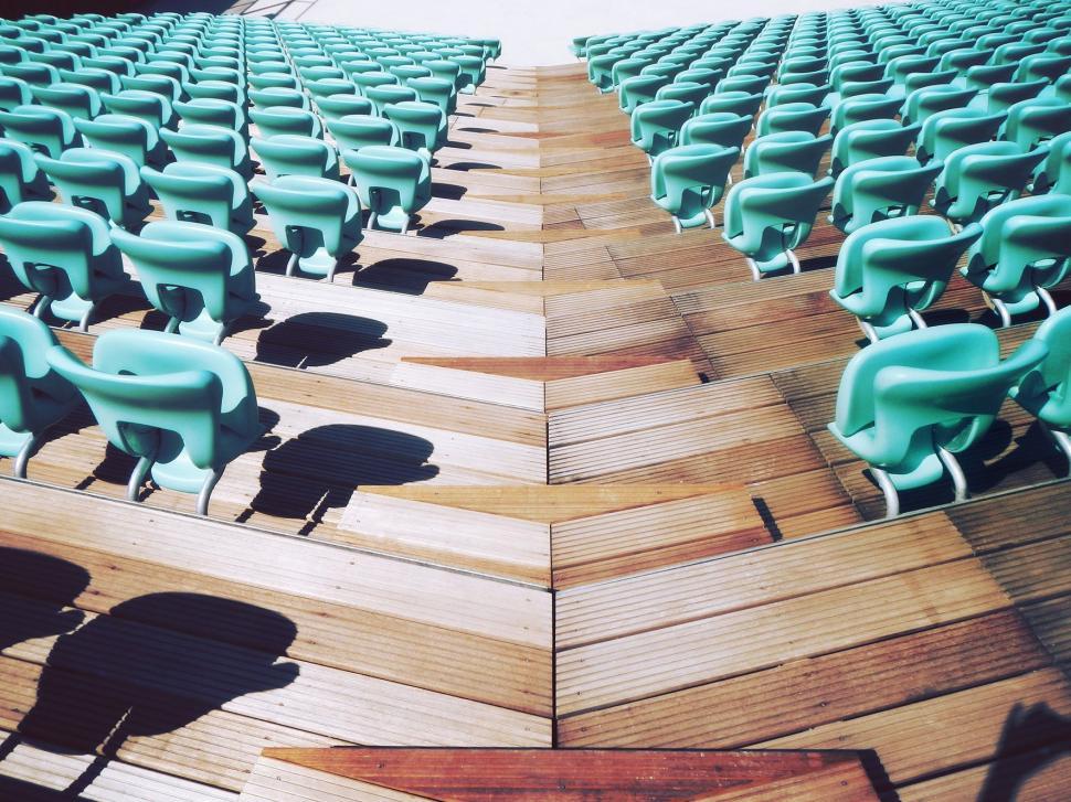 Free Image of Row of Blue Chairs on Wooden Floor 