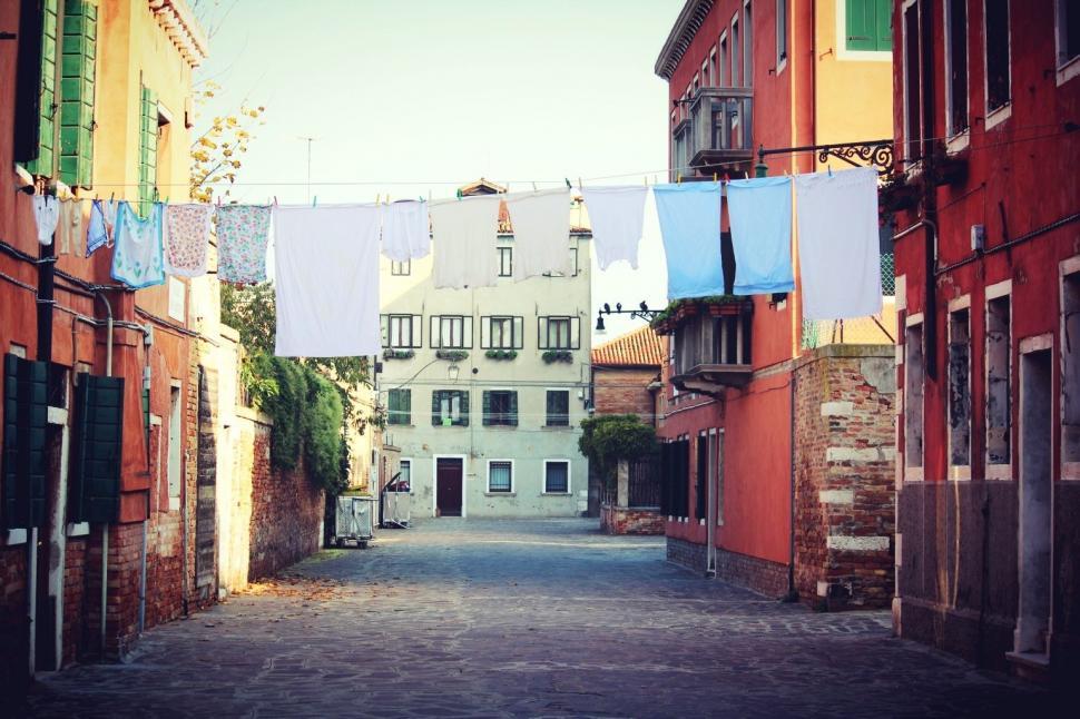 Free Image of Narrow Alley With Clothes Hanging on a Line 