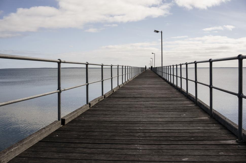 Free Image of Long Pier Extending Into Water 