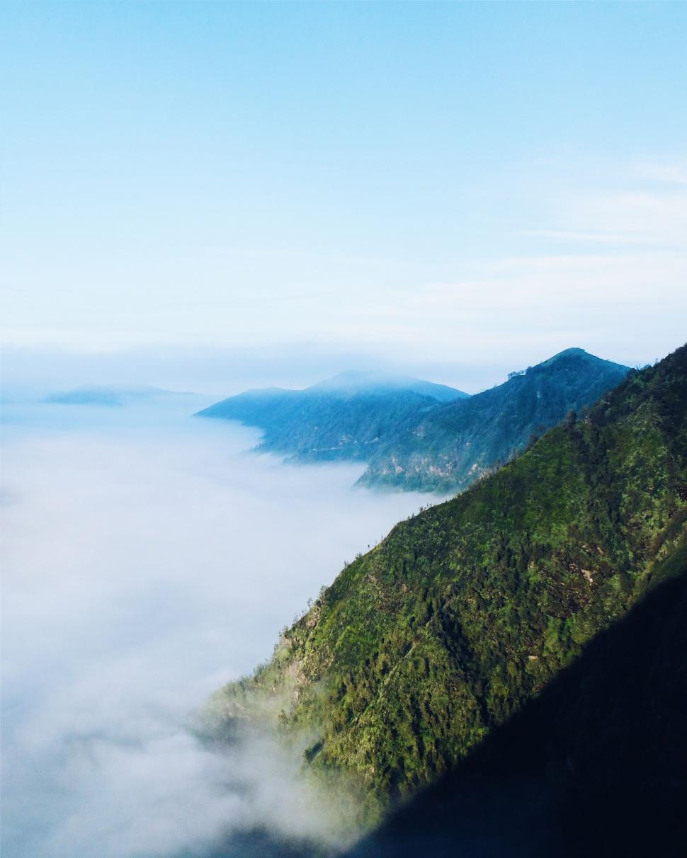 Free Image of Aerial View of Mountain With Low Lying Clouds 