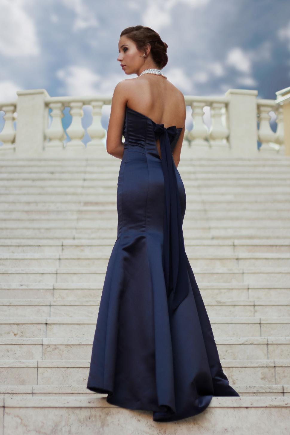 Free Image of Woman in Blue Dress Standing on Steps 