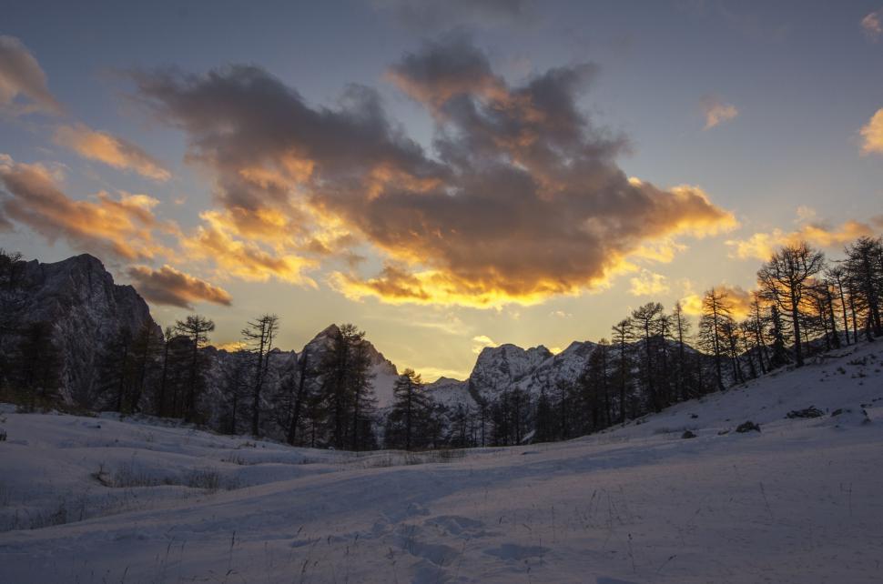 Free Image of Sun Setting Over Snowy Mountains 