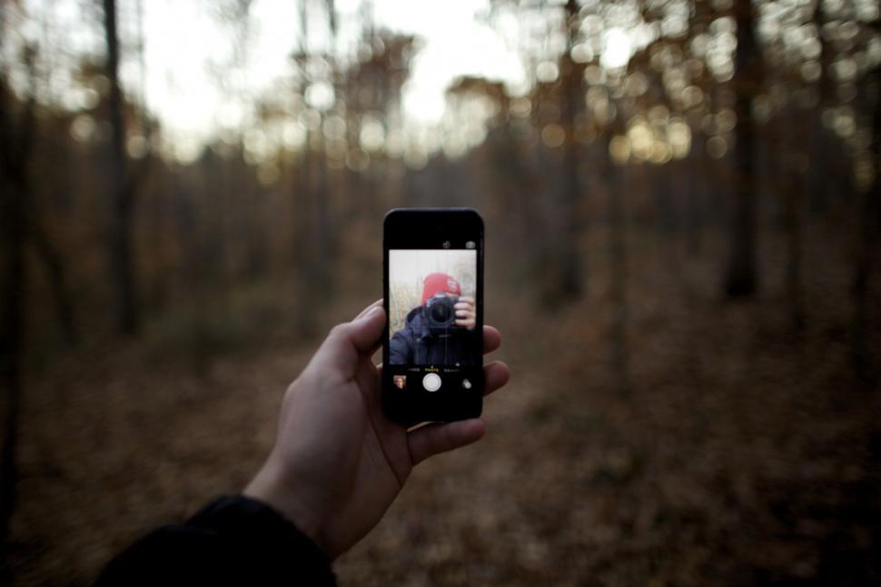 Free Image of Person Taking Picture of Another in the Woods 