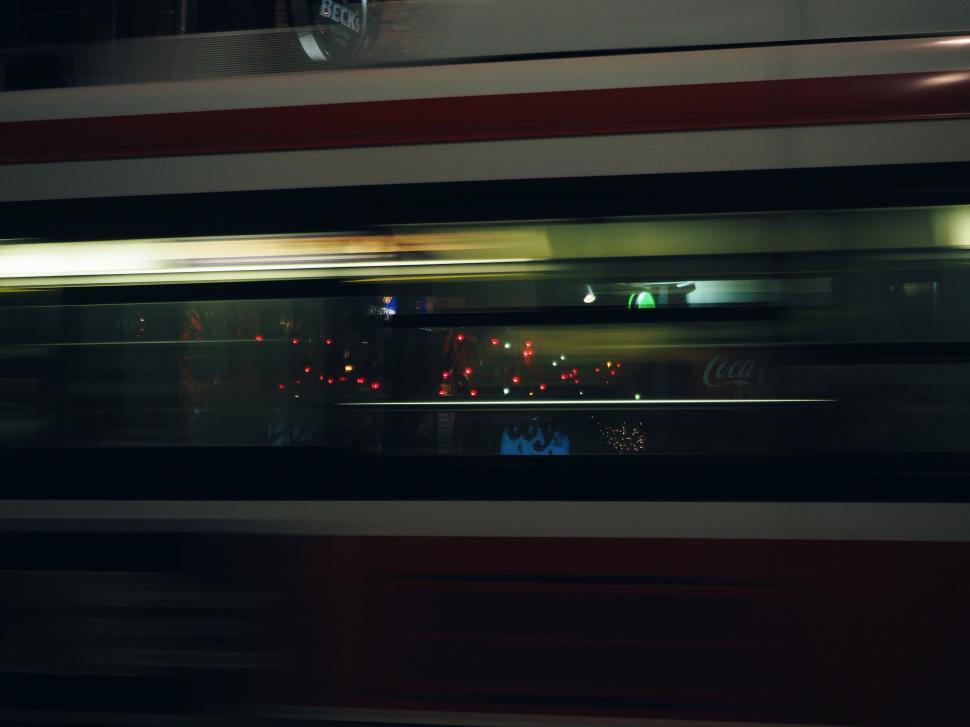Free Image of Blurry Photo of a Train Moving Through the Night 