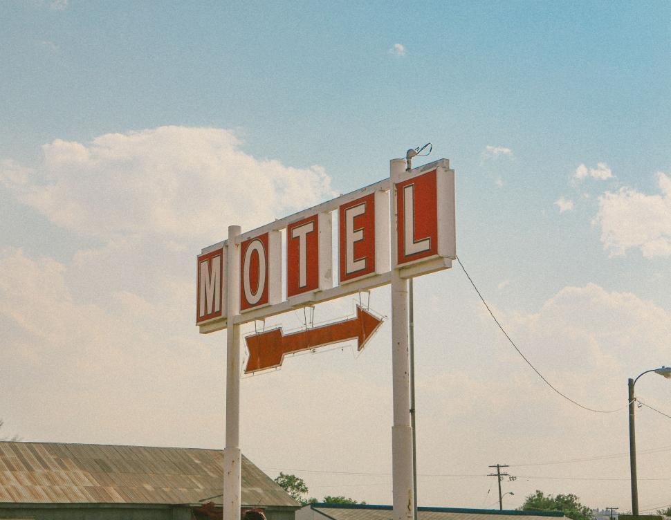 Free Image of Motel Sign With Arrow Pointing Left 