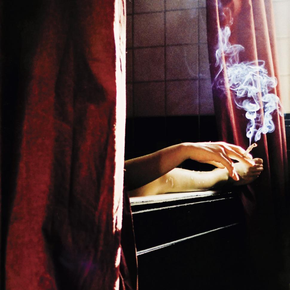 Free Image of Person Sitting in Bathtub With Cigarette 