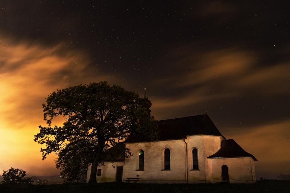 Free Image of Church With Tree Under Cloudy Sky 