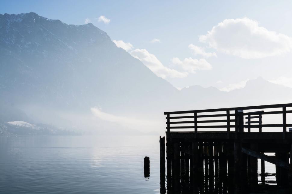 Free Image of Person Sitting on Bench Near Water 