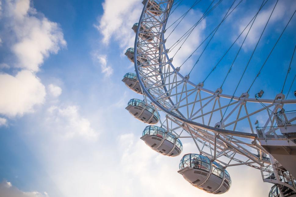 Free Image of Large Ferris Wheel Under Cloudy Blue Sky 