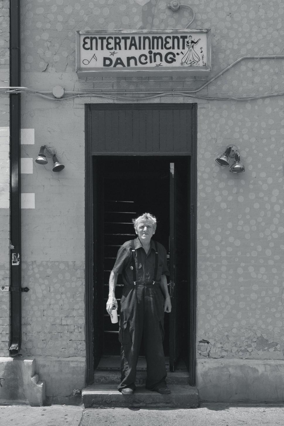 Free Image of Man Standing in Doorway of a Building 
