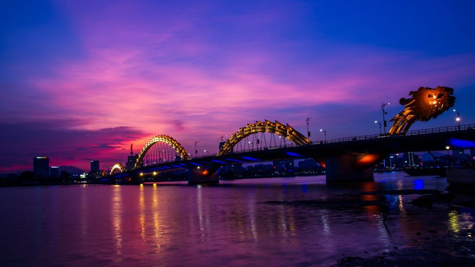 Free Image of city waterfront bridge cityscape water architecture skyline travel building sky river urban boat tourism night sea town harbor reflection steel arch bridge buildings structure tower landmark europe sunset landscape 