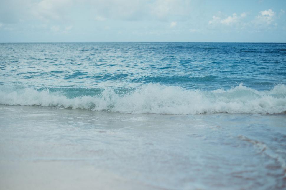 Free Image of Beach With Wave Rolling Towards Shore 