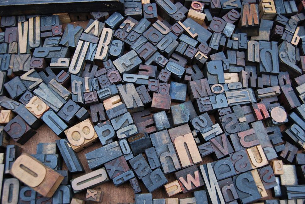 Free Image of Stack of Old Wooden Letterpresses on Table 