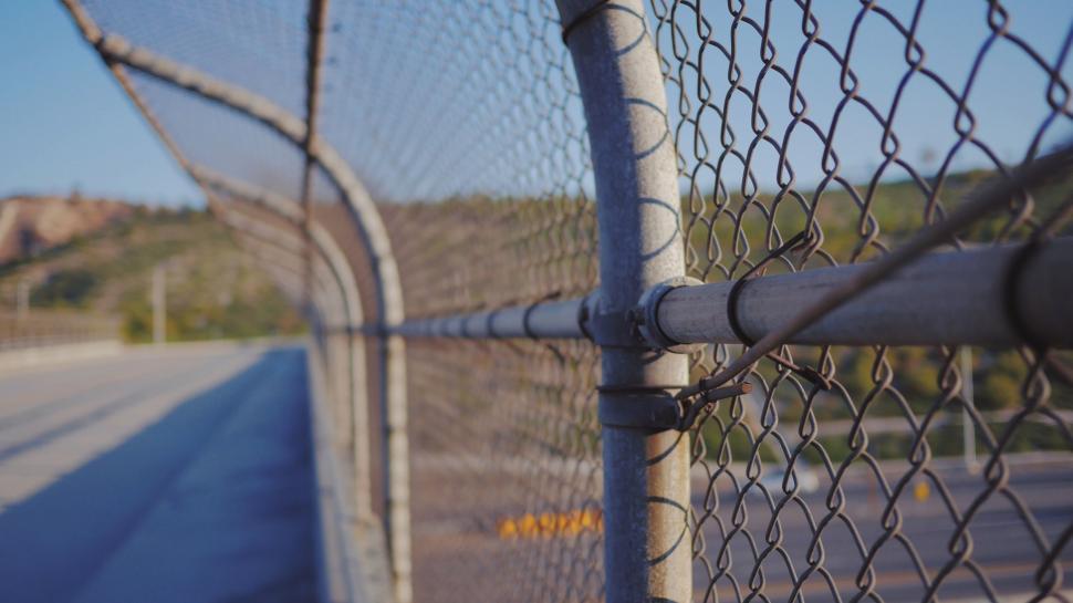 Free Image of Close Up of a Fence With a Road in the Background 