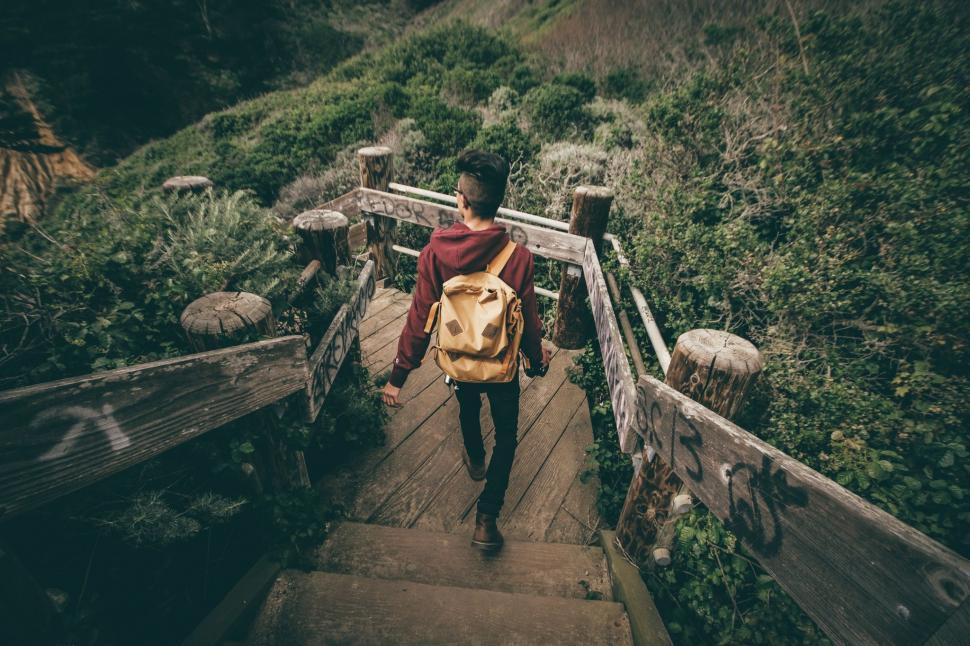 Free Image of Man Walking Up Stairs With Backpack 