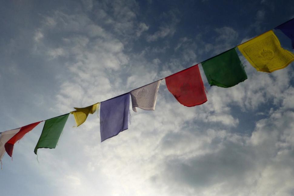 Free Image of Multicolored Flags Flying in the Sky 
