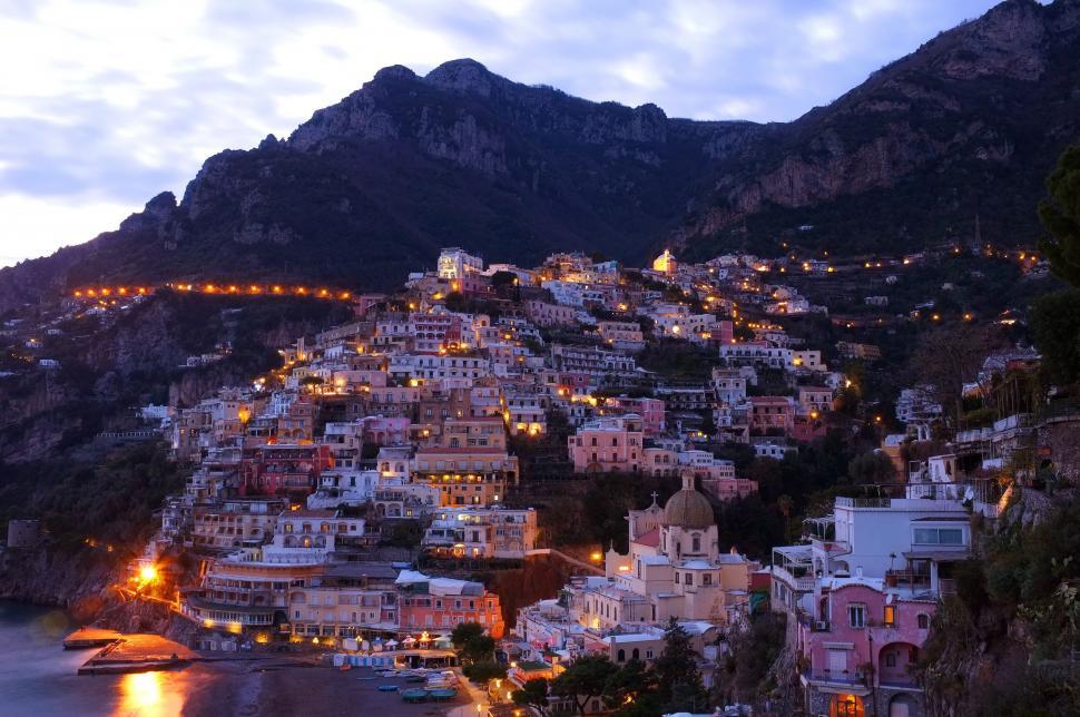 Free Image of Night Time View of Town on Cliff 
