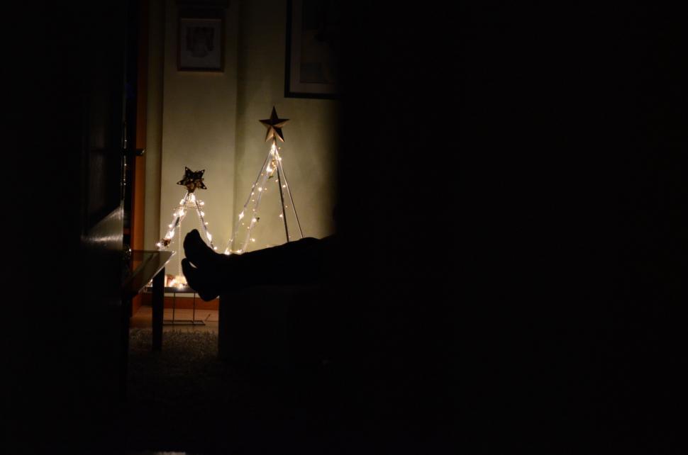 Free Image of Cat Sitting on Chair in Dark Room 