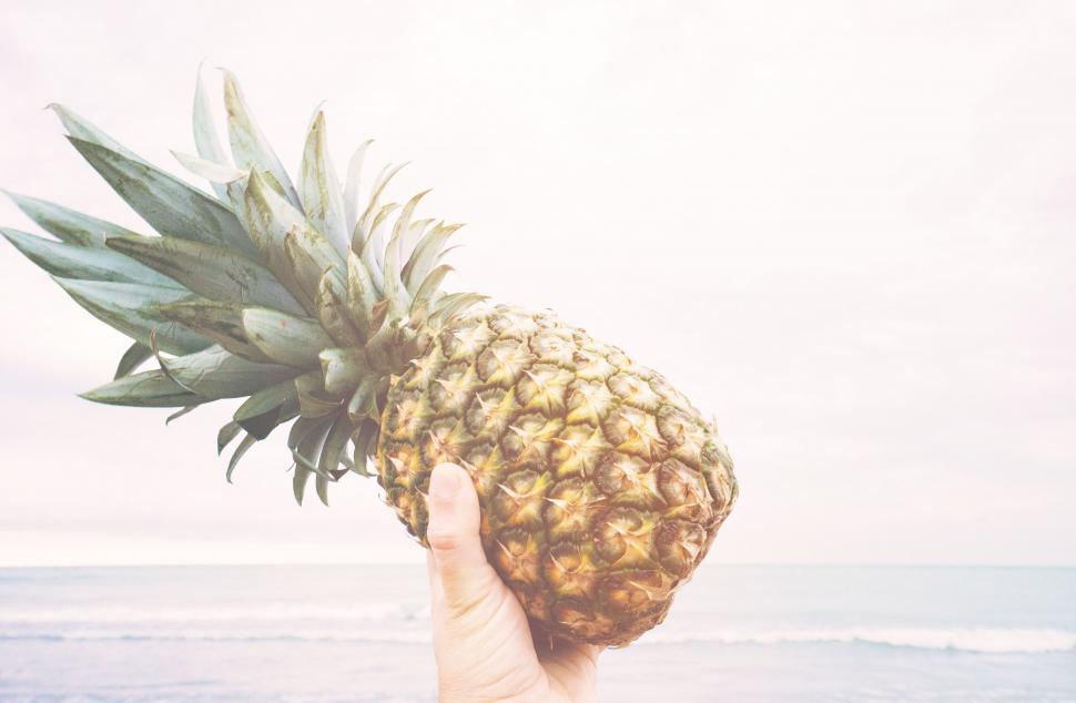 Free Image of Person Holding Pineapple Up to Camera 