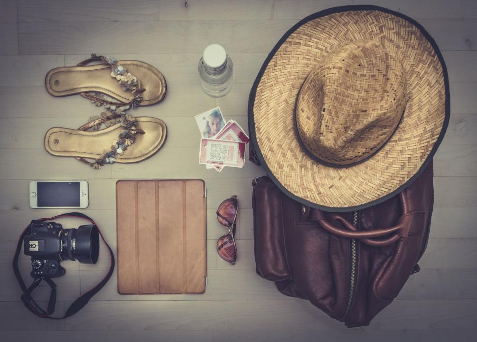 Free Image of Table With Hat, Sandals, Camera, and Various Items 