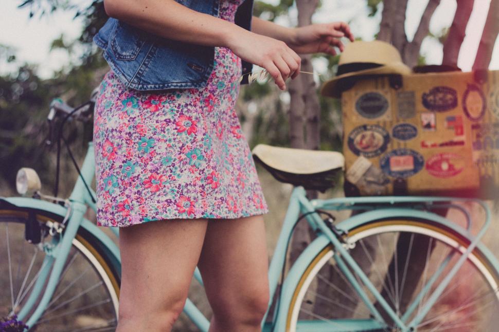 Free Image of Woman Standing Next to Blue Bicycle 
