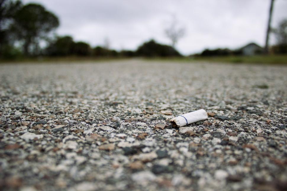Free Image of Cigarette Abandoned on Ground in Middle of Road 