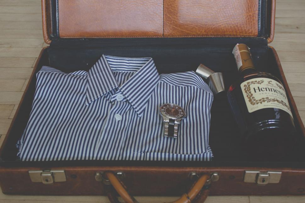 Free Image of Suitcase With Wine Bottle and Shirt 