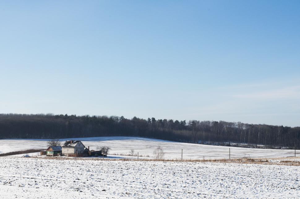 Free Image of Snow Covered Field With Distant House 