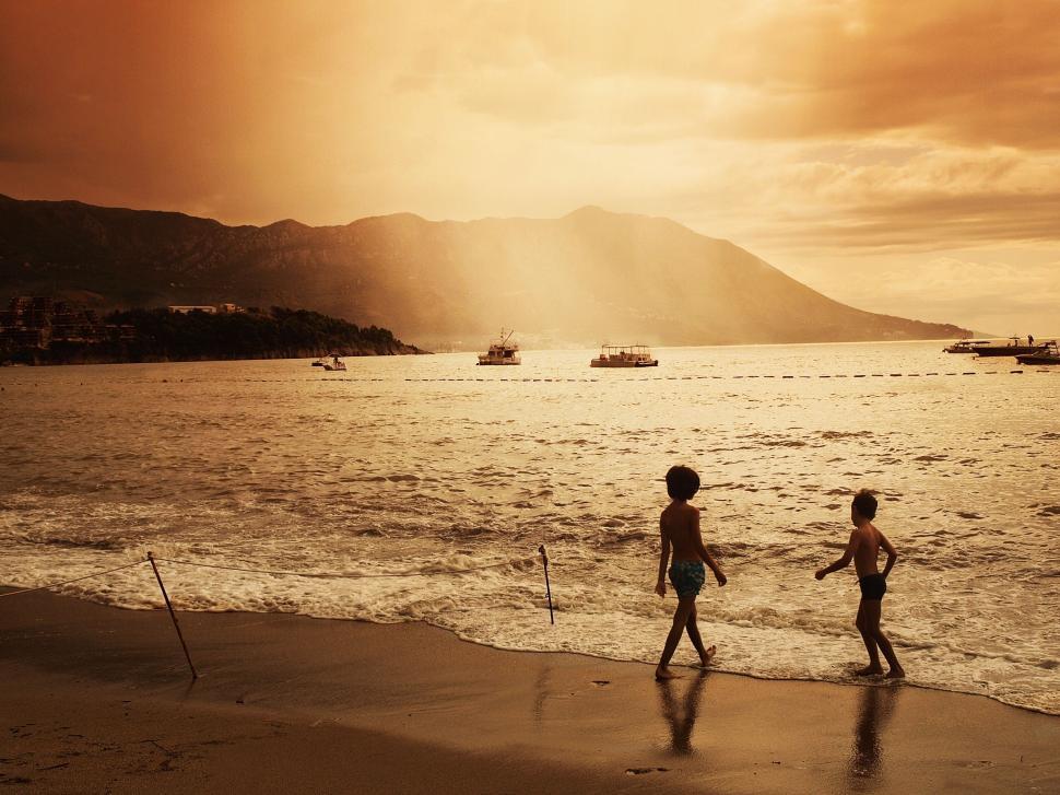 Free Image of Kids Walking on Beach 
