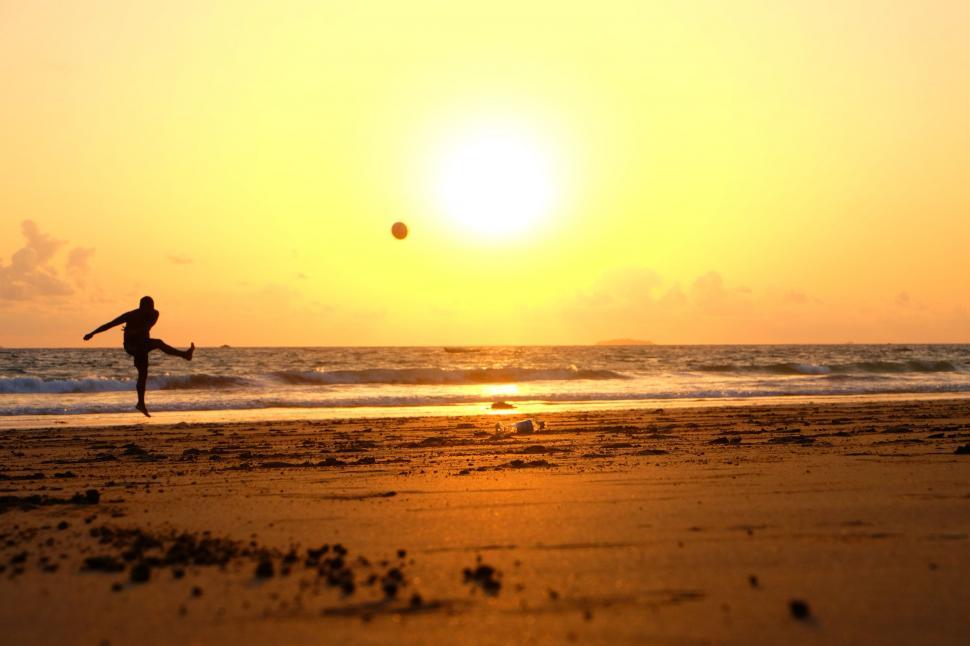 Free Image of Person Playing With Ball on Beach 