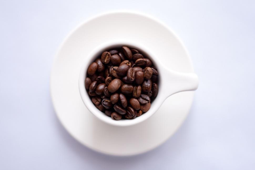 Free Image of White Cup Filled With Coffee Beans on White Table 