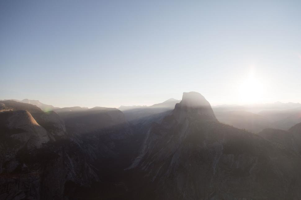 Free Image of Majestic Mountain Range With Sun Setting in the Distance 