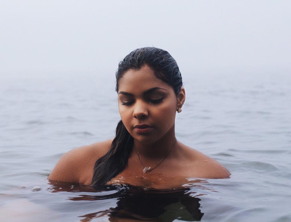 Free Image of Woman Closing Eyes in Body of Water 