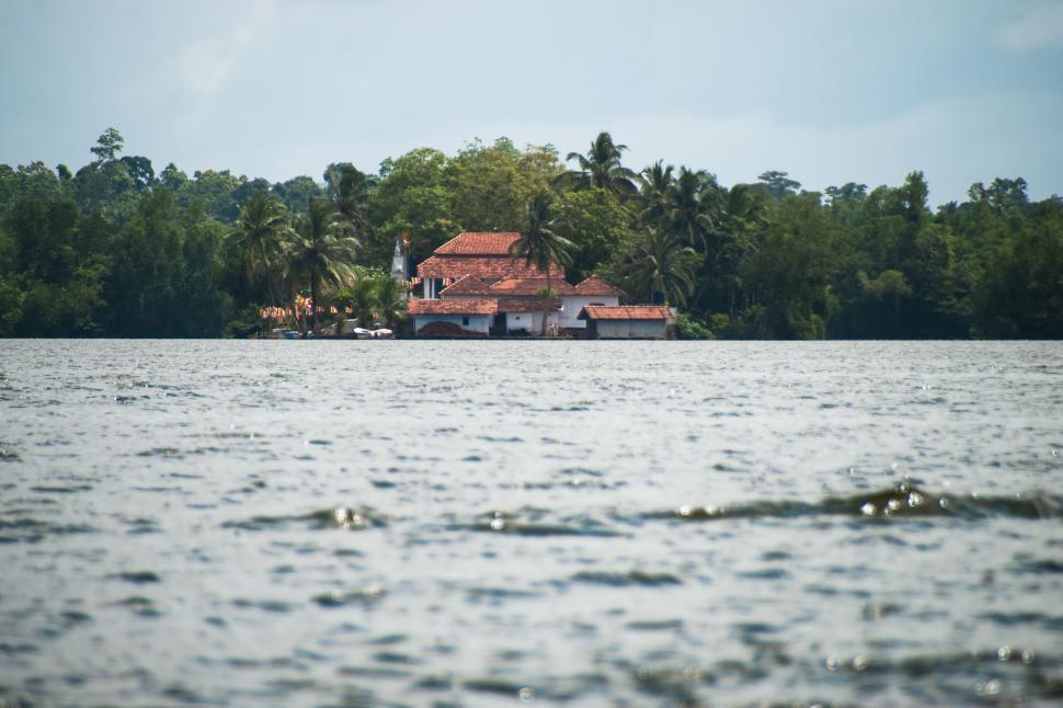 Free Image of House Overlooking Large Body of Water 