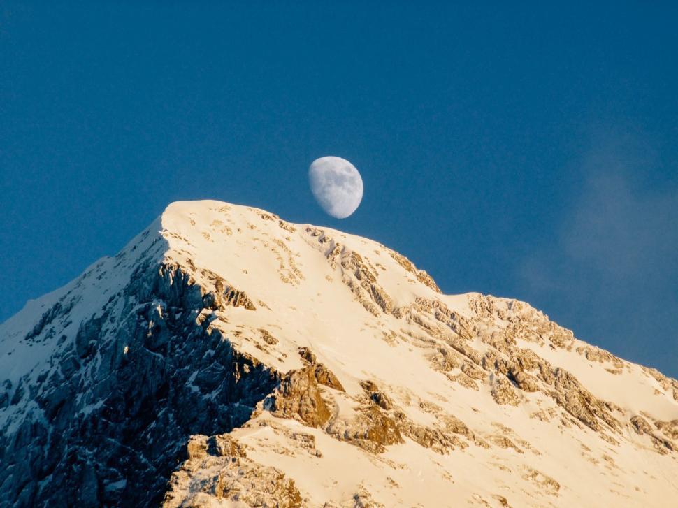 Free Image of Moon Setting Over Snowy Mountain 