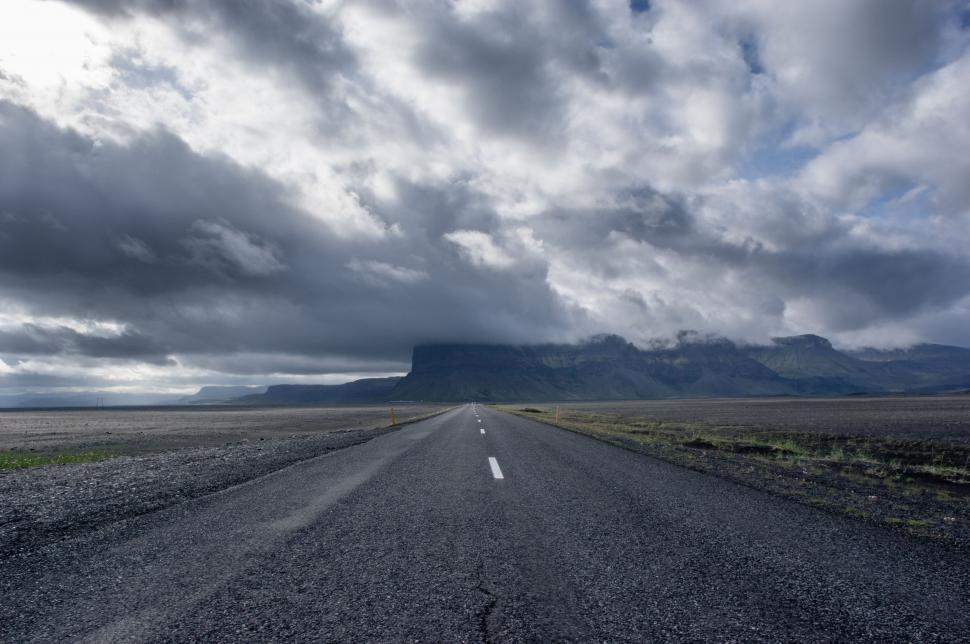 Free Image of Long Empty Road With Mountain in Background 
