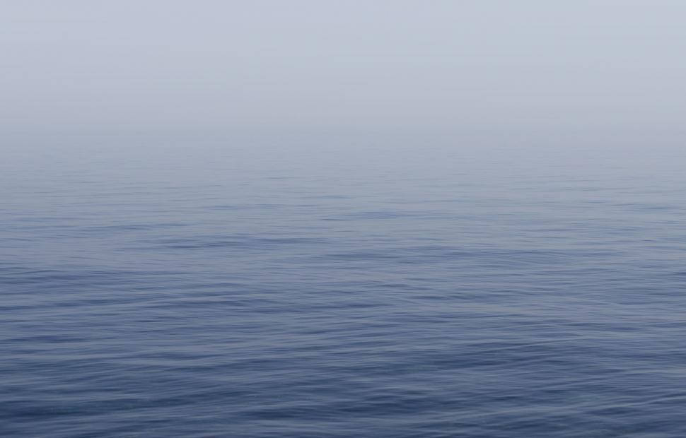 Free Image of Boat Floating in Ocean on Foggy Day 
